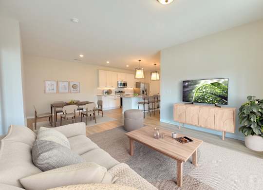 A living room with a grey couch and a wooden coffee table.