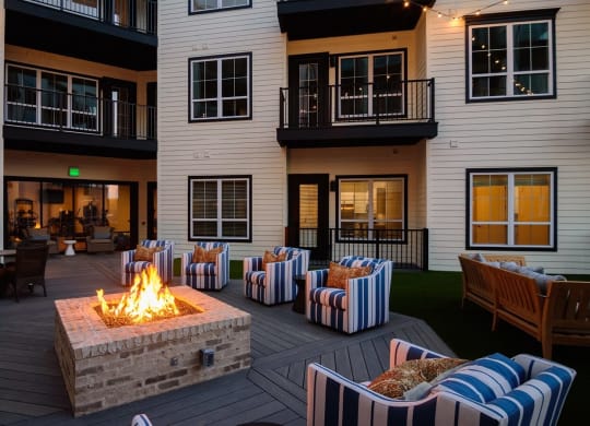 an outdoor patio with a fire pit and chairs  at Essex, Columbus, 43212
