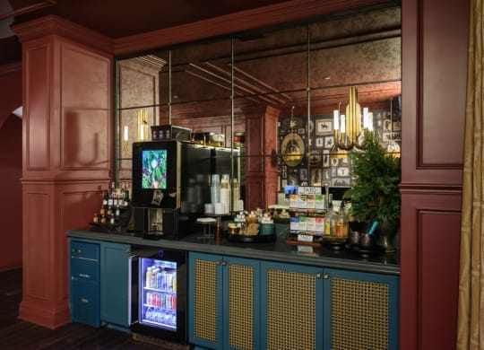 a bar with blue cabinets and a large mirror behind it at Fairfax, Grandview, Ohio