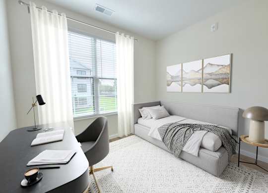 A bedroom with a bed, chair, and desk.