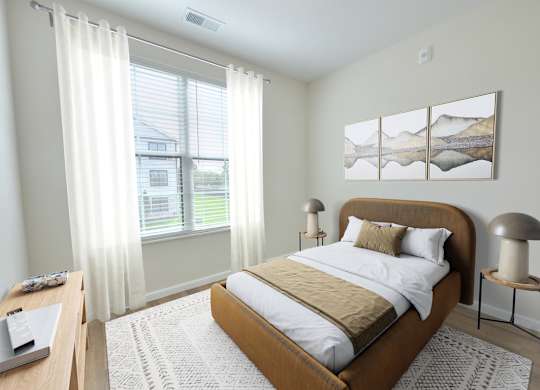 A bedroom with a large bed and a painting on the wall.