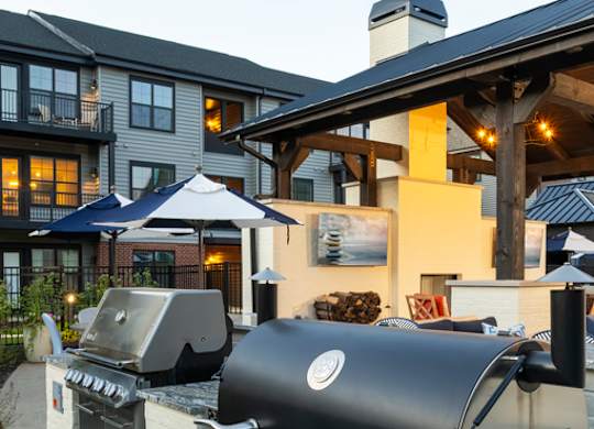 A black grill is in front of a building.