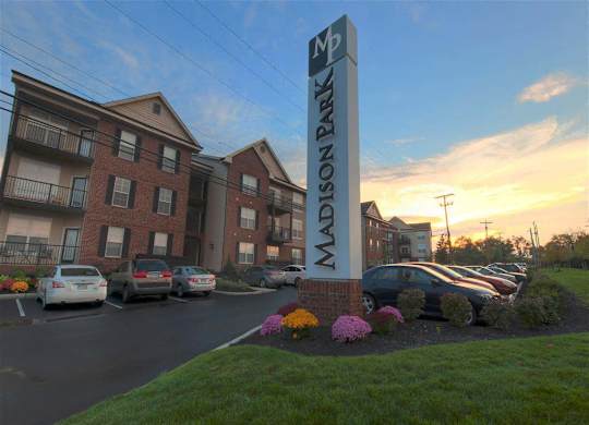 A sign for apartment buildings with the name