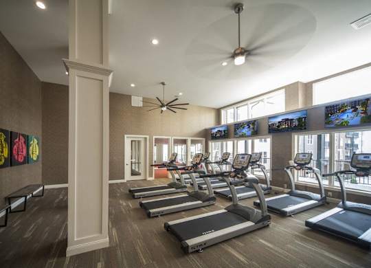 A gym with treadmills and exercise bikes.