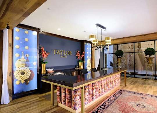 A Taylor branded kitchen with a black counter top and a wooden floor.