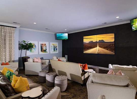 A living room with a large screen TV and a couch.