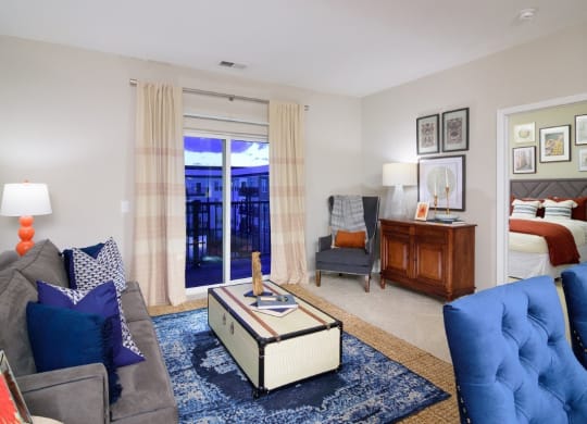 a living room with a couch and a chair and a bedroom with a bed at Taylor House, Columbus, OH