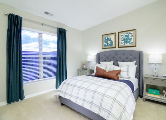 a bedroom with a large window and a bed at Taylor House Apartments, Columbus, OH, 43214