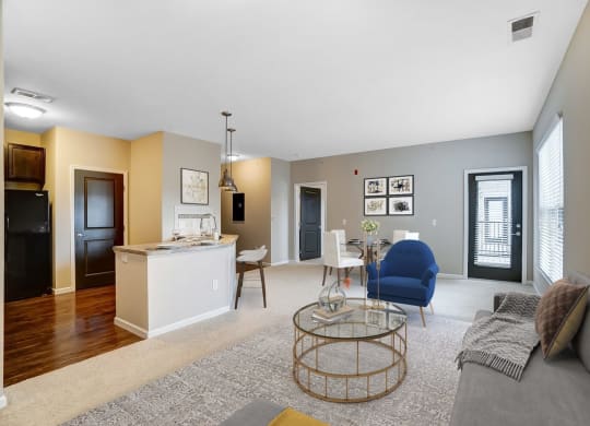 a living room and kitchen with a couch and a tableat Taylor House Apartments, Columbus, Ohio