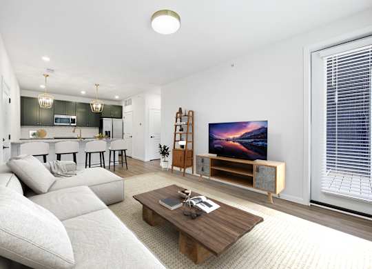 A modern living room with a large couch and a flat screen TV.