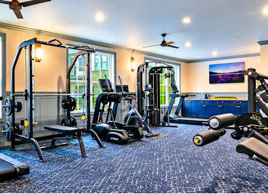A spacious home gym with a variety of exercise equipment.