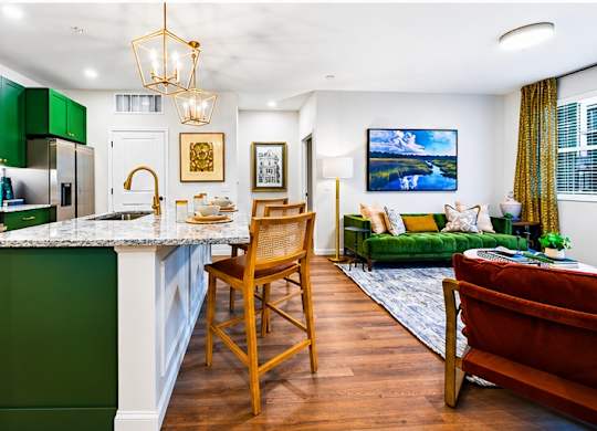 A kitchen with green cabinets and a white countertop.