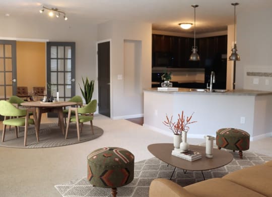 a living room and kitchen with a table and chairs