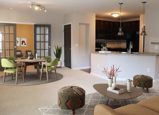a living room and kitchen with a table and chairs