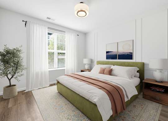 A bedroom with a large bed and a potted plant.