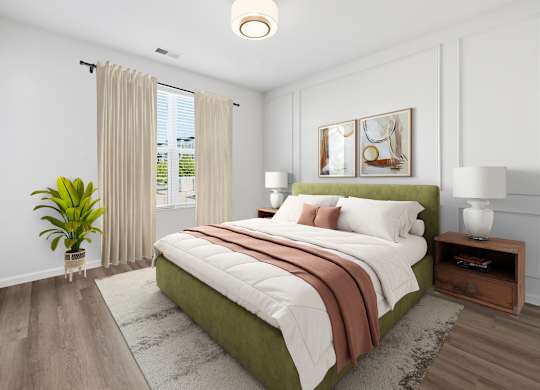 A bedroom with a large bed and a potted plant.