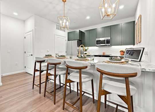 A kitchen with white walls and a wooden floor.