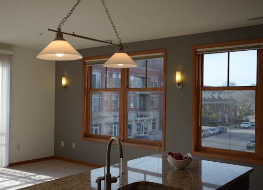 A kitchen with a table and two chairs at Cornerstone & Ravenna* Apartments, Shorewood, WI