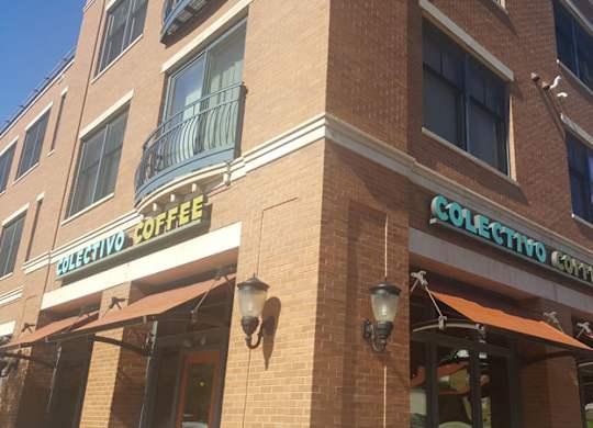 A brick building with a sign that says Selecto Coffee at Cornerstone & Ravenna* Apartments, Shorewood, Wisconsin