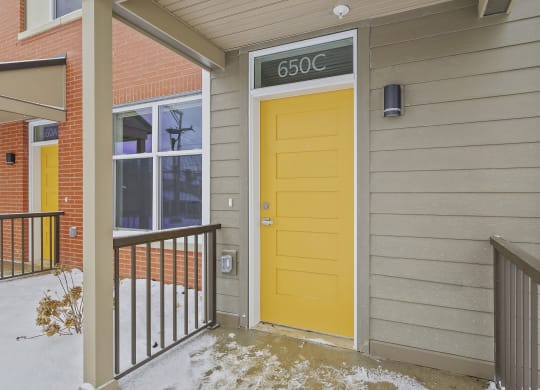 the front door of a house with a yellow door