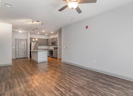 Living room with a ceiling fan and a kitchen in the background at The Parker Myrtle Beach, Myrtle Beach