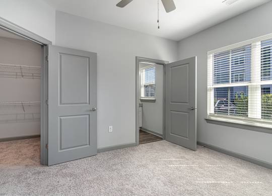 Bedroom with two closets and a ceiling fan at The Parker Myrtle Beach, South Carolina, 29588