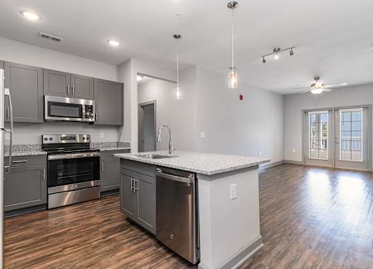 Kitchen and living room with an island and stainless steel appliances at The Parker Myrtle Beach, South Carolina
