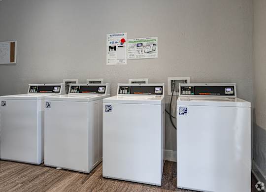 Four White Washing Machines at Avondale Place Apartments, Avondale Estates, GA