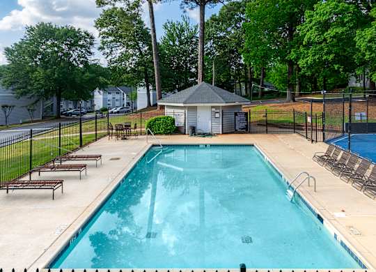 A Swimming Pool With Relaxing Area at Avondale Place Apartments, Georgia