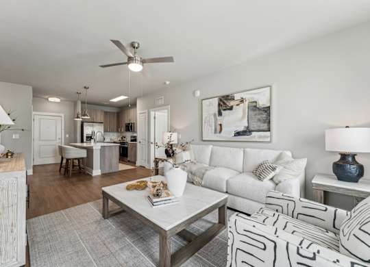 A modern living room with a white couch and a coffee table at The Hendry Apartments, Florida