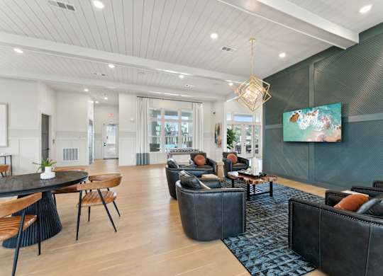 A modern living room with a black couch and a painting on the wall at The Hendry Apartments, Florida, 33905