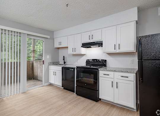 A Kitchen With Black Appliances at Avondale Place Apartments, Avondale Estates, 30002