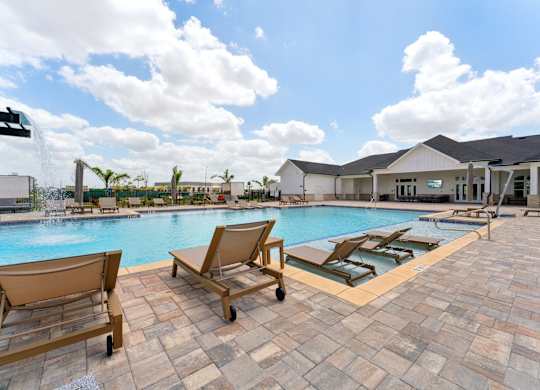 sparkling pool with seating around at The Hendry Apartments, Fort Myers, 33905
