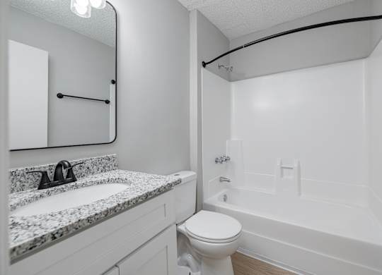 A Bathroom With Marble Countertop at Avondale Place Apartments, Avondale Estates, GA