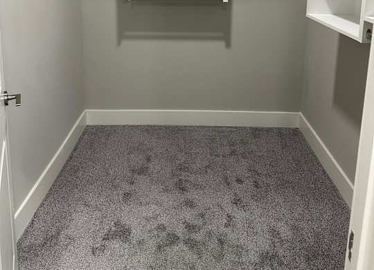 A small, empty room with a white door and a white shelving unit at The Beacon at 331 Apartments, Santa Rosa Beach, 32459