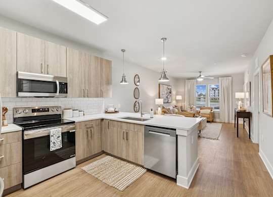 A modern kitchen with wooden cabinets and stainless steel appliances.at The Beacon at 331 Apartments, Santa Rosa Beach, FL