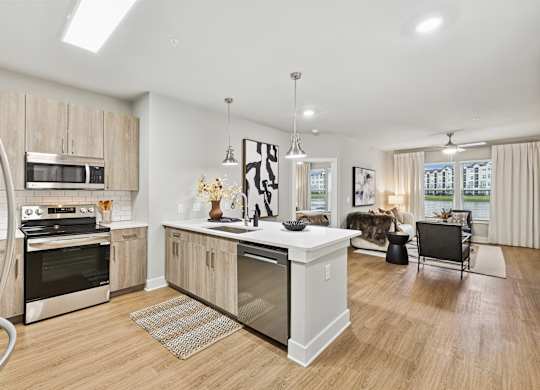 A modern kitchen with wooden cabinets and stainless steel appliances.at The Beacon at 331 Apartments, Santa Rosa Beach