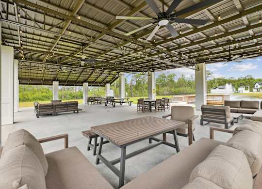 A patio with a table and chairs under a roof.