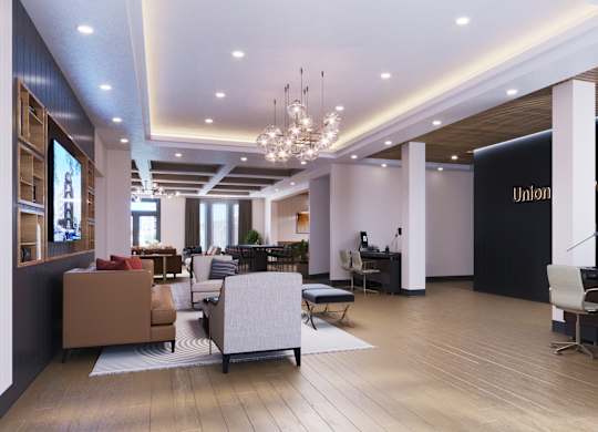 A modern office lobby with a reception desk and a large plant.
