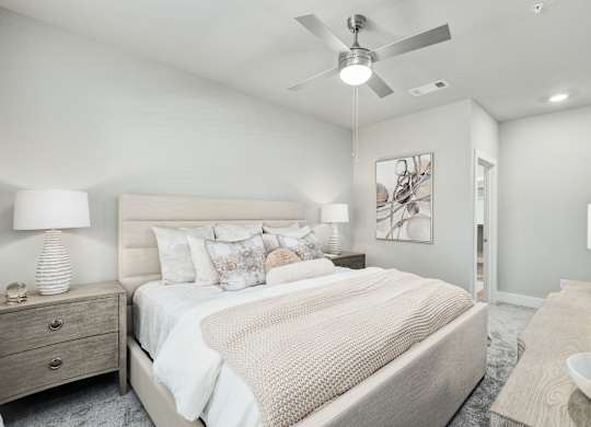 A bedroom with a large bed and a ceiling fan at The Ashton at East Park Apartments, Kennesaw