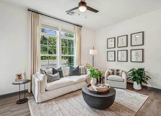 a living room with a couch and a chair and a ceiling fan at The Leo Myrtle Beach, Myrtle Beach, SC