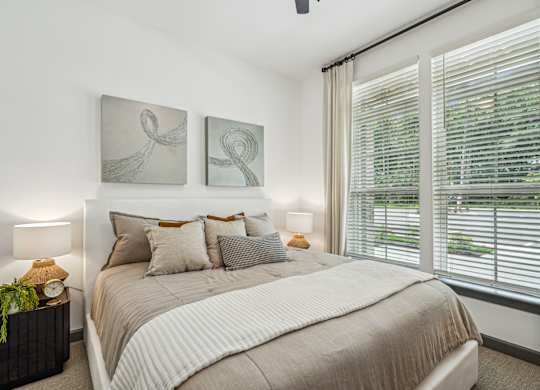 a bedroom with a bed and two paintings on the wall at The Leo Myrtle Beach, Myrtle Beach, SC, 29579