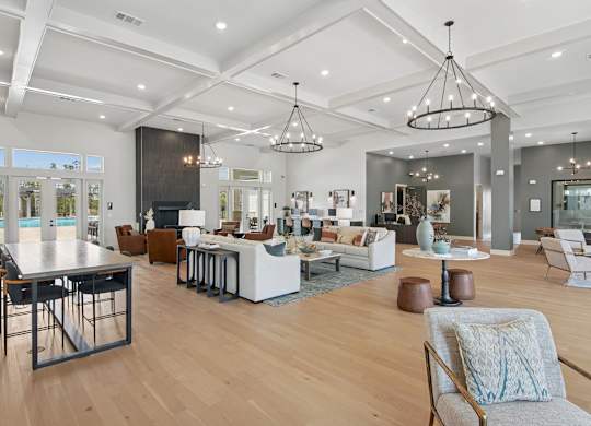 A modern living room with a pool table and a dining table at The Hendry Apartments, Fort Myers, 33905