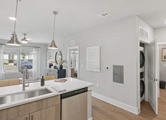 A modern kitchen with a white countertop and stainless steel appliances at The Hendry Apartments, Fort Myers, Florida