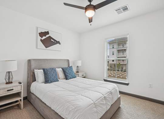 a bedroom with a large bed and a ceiling fan at The Leo Myrtle Beach, Myrtle Beach, SC