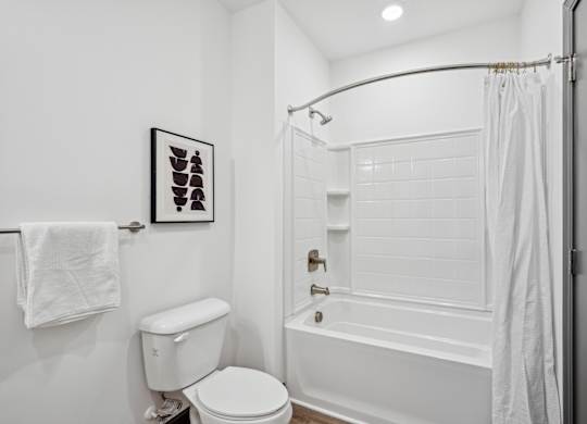 a white bathroom with a shower and a toilet at The Leo Myrtle Beach, South Carolina, 29579