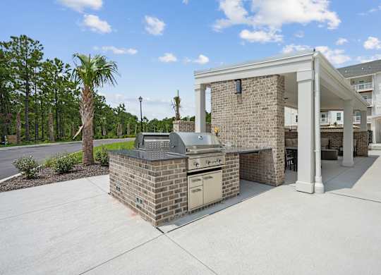 Outdoor kitchen with a grill and a pavilion at The Leo Myrtle Beach, South Carolina, 29579