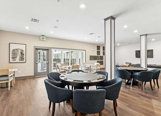 a dining room with a round table and chairs at The Leo Myrtle Beach, South Carolina