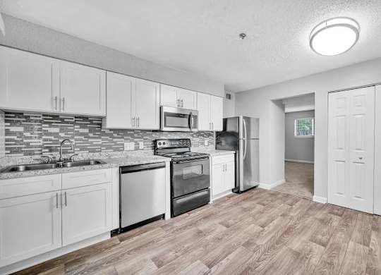 A Kitchen With White Cabinets at Avondale Place Apartments, Avondale Estates, 30002