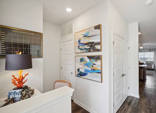 A living room with white walls and two paintings on the wall  at The Meadows, Bloomingdale, Georgia